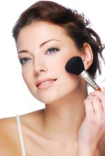 woman with beautiful skin applying mineral makeup